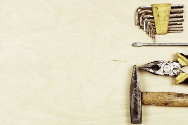 Retro vintage ahşap ekipman seti. Çekiç pense tornavidayı kahverengi desenli tahta arka planda. Kullanışlı eski paslı aletler konsepti. Üst görünüm düzlüğü. 