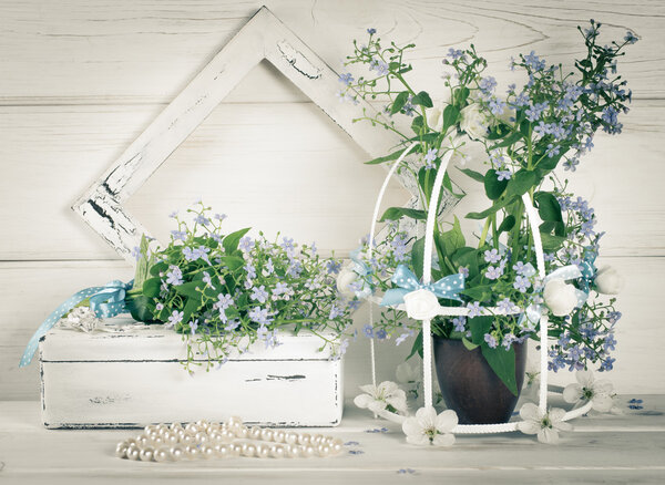 Forget-me-not flowers with birdcage and photo frame and casket w