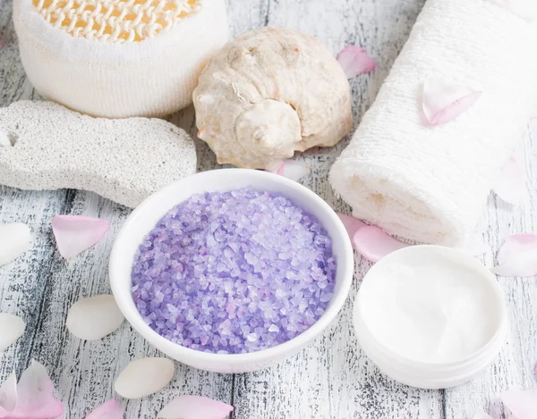 Spa salon with sea salt, towel, pumice, cream and roses petal — Stock Photo, Image