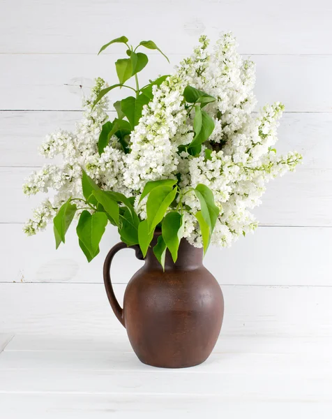 Lilac Bouquet in clay jug on background — Stock Photo, Image