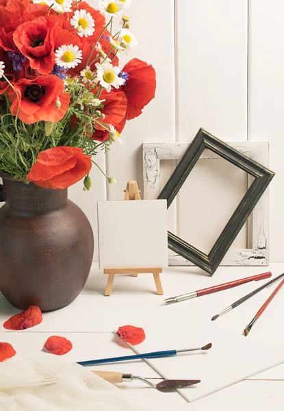 Art workshop with artistic equipment and composition poppies in — Stock Photo, Image