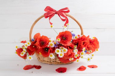 Haşhaş ve papatya buketi sepeti ahşap plakalar üzerinde 