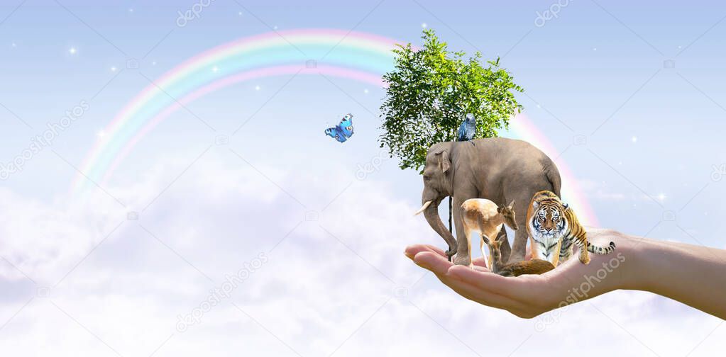 World Animal Day, Wildlife Day concept. Elephant, tiger, deer, parrot, tree in hand and rainbow in sky. Saving planet, protect nature reserve, protection of endangered species and biological diversity.