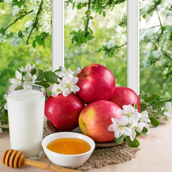 Stilleben med äpplen, honung, mjölk och trädgård utanför windo — Stockfoto
