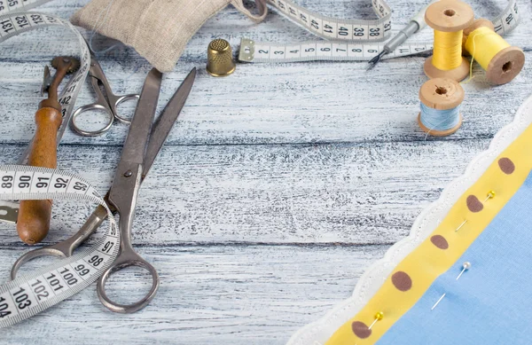 Set of reel of thread, scissors, fabric and pins for sewing — Stock Photo, Image