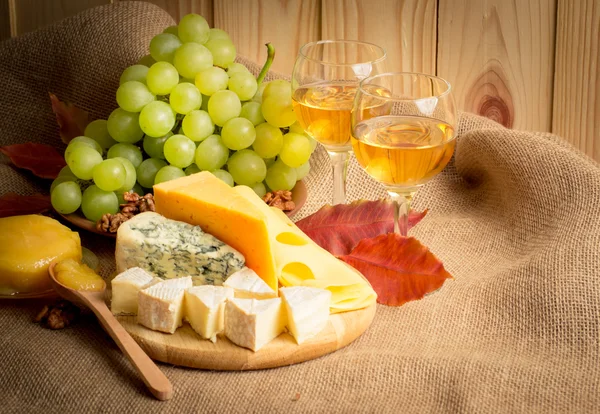 White wine with cheese, honey, walnuts and grapes on sackcloth — Stock Photo, Image