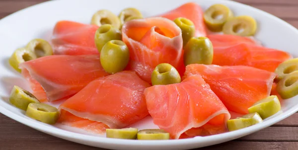 Sliced salted salmon served with olive — Stock Photo, Image