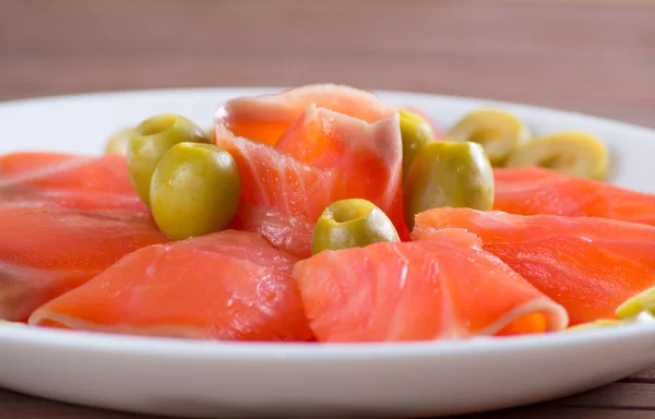 Sliced salted salmon served with olive — Stock Photo, Image