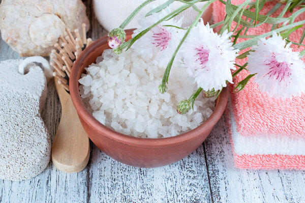 Spa salon with sea salt, towels and flowers