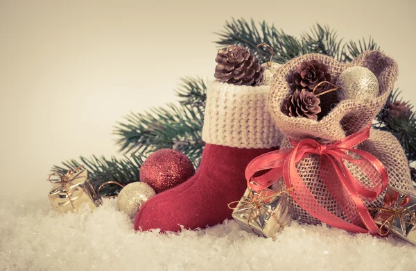 Santa's boot and gift bag on snow. — Stock Photo, Image