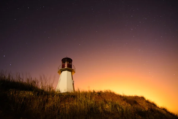 Fyr med natthimlen på bakgrunden stjärnor spår — Stockfoto