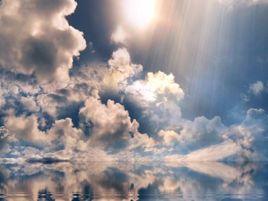 dramatical cloudy sunbeam  colorful sunset on blue  sky yellow clouds skyline, water sea reflection beautiful landscape summer nature