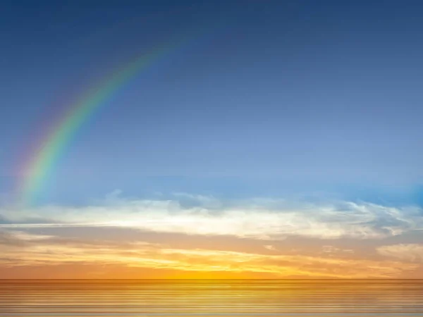 rainbow at  sunset at sea yellow pink blue pastel colors  sun  beam reflection on light blue sea water nature lanscape