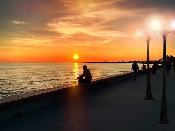 Sylwetka Mężczyzny Siedzącego Parapecie Zachód Słońca Promenadzie Molo Ludzie Relaks — Zdjęcie stockowe