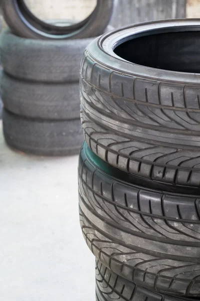 Stack of old tires in a car shop garage — Stock Photo, Image