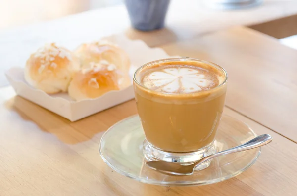 A cup of coffee on wooden background, latte art — Stock Photo, Image