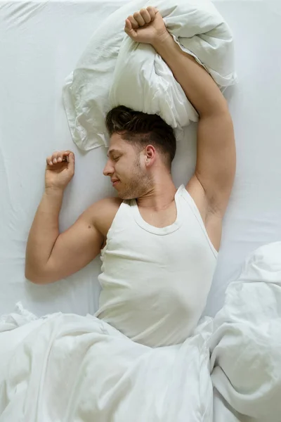Bedtime Top View Muscular Young Man White Shirt Stretches Bed — Stock Photo, Image