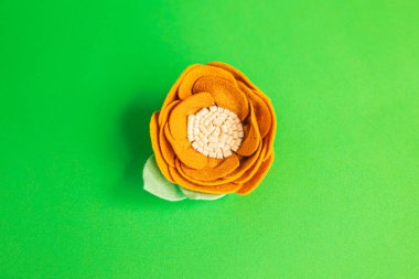 Çiçek şeklinde kızlar için dekoratif saç keçeli bant. El yapımı. Yeşil arkaplan