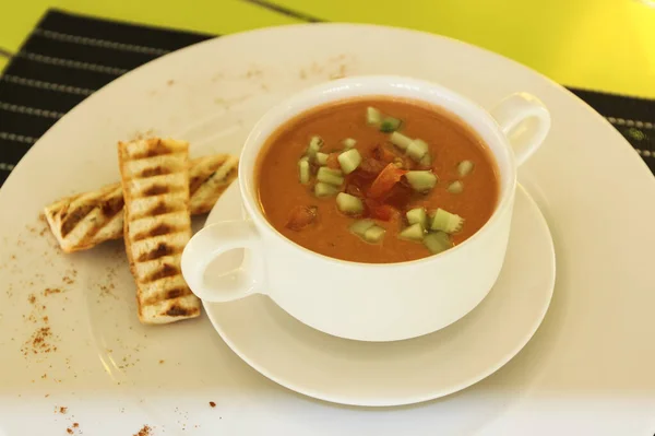 Soup in a cup on the table. Table setting in a restaurant.