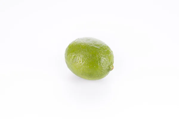 A whole fresh lime isolated on a white — Stock Photo, Image