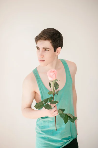 Handsome young man with pink rose — Stock Fotó