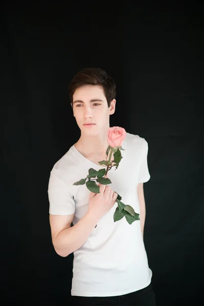 Handsome young man with pink rose — Stock Fotó