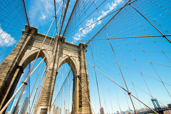 The archways and ropes of Brooklyn Bridge, New York, USA.