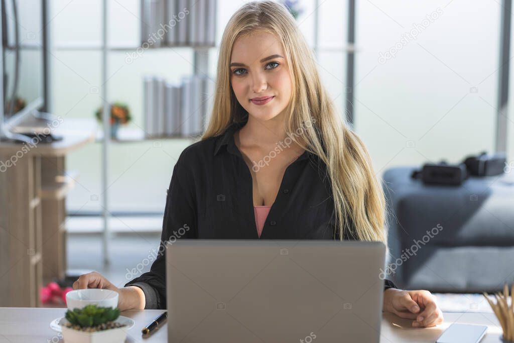 Young business woman working from home-office with morning sunshine. woman communicating in social network and searching information online.