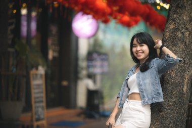 Uzun saçlı güzel Asyalı kadın Tayland 'daki Yaowarat Çin Mahallesi' ndeki festivale gidiyor. Gece gezgin kadının sokak fotoğrafçılığı.