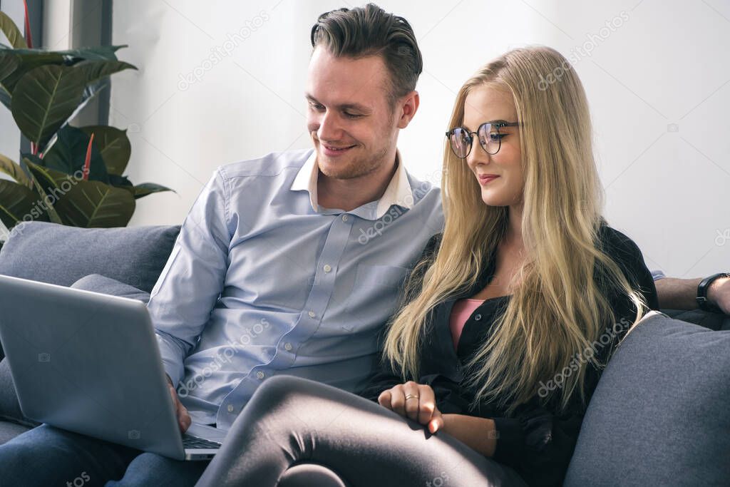 Young business man and woman working from home-office with morning sunshine. they are communicating in social network and searching information online.