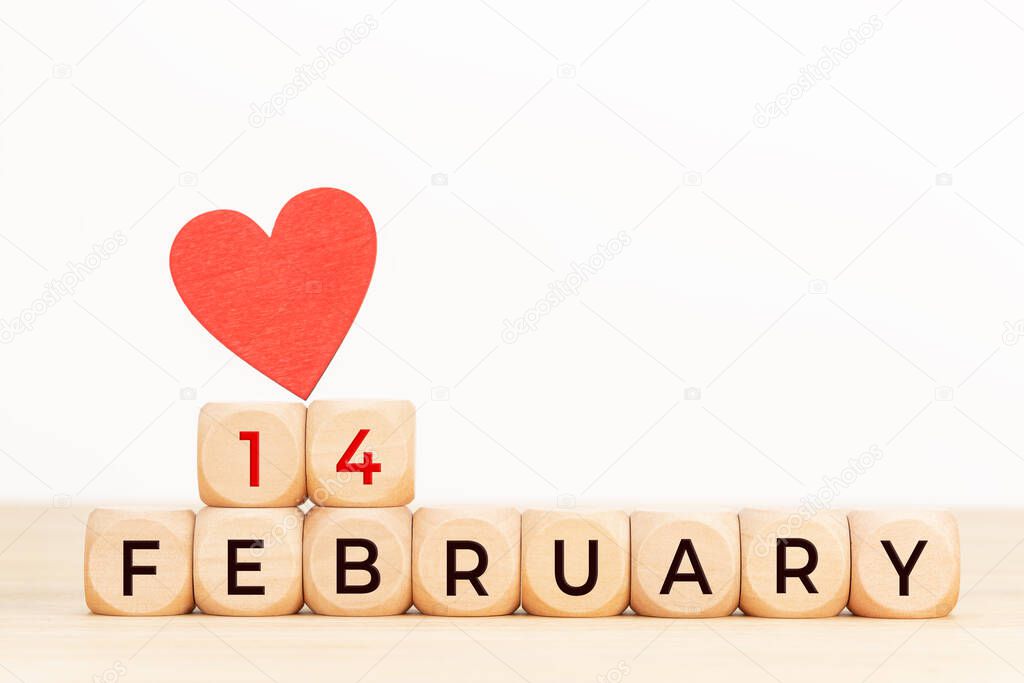 14 february text on wooden blocks and heart shaped on table. Valentines day concept. Copy space