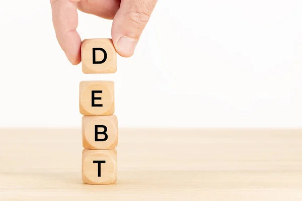 Debt Concept Hand Holding Pile Wooden Blocks Table White Background — Stock Photo, Image