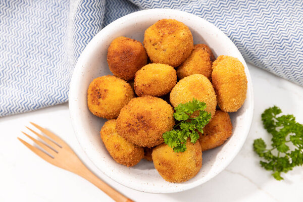 Homemade croquettes in a ceramic bowl. Typical spanish appetizer. Top view