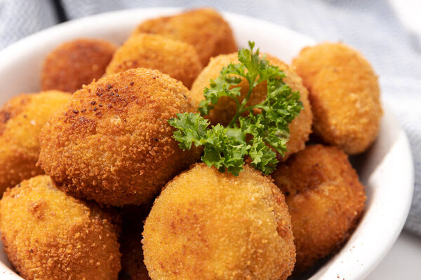 Homemade croquettes in a ceramic bowl. Typical spanish appetizer. Close up view