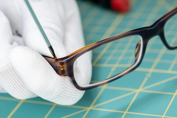 Mãos Ópticas Reparando Óculos Com Uma Ferramenta Fechar — Fotografia de Stock