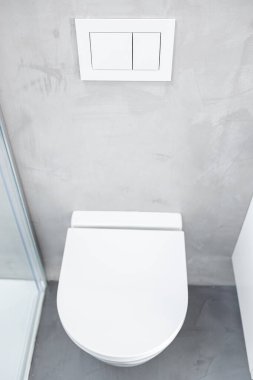 Ev banyosunda sifonu çekerek duvara monte edilmiş ya da askıya alınmış tuvalet ya da tuvalet.