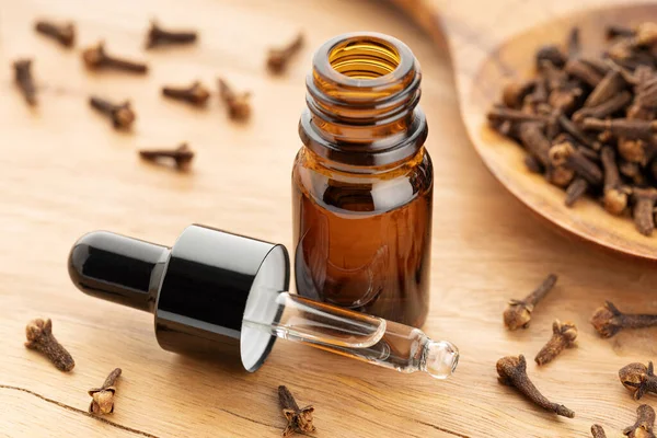 Clove Essential Oil Bottle Wooden Table Alternative Medicine — Stock Fotó