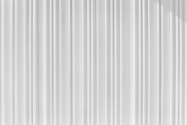 Decorative concrete vertical groove pattern of a building facade. Grooved White cement background