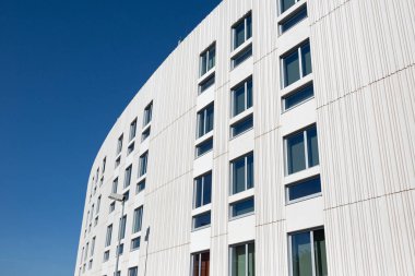 Modern apartment building with decorative grooved concrete facade. Copy space