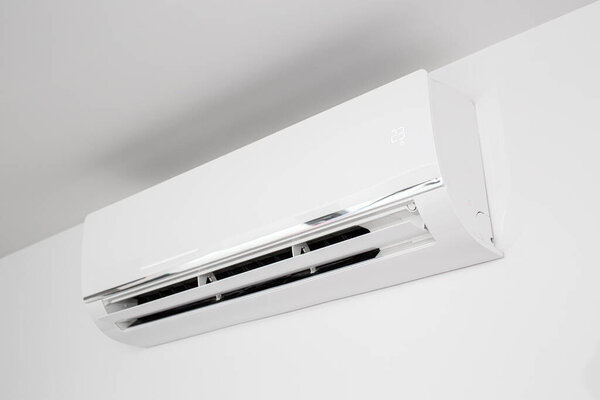 Domestic Indoor Air conditioner unit mounted on wall used for heating or cooling a space. Working at 23 degree celsius