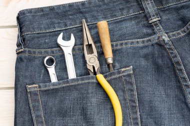 Set of tools in in jeans pocket. Labor day background concept