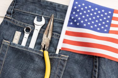 Set of tools and american flag in jeans pocket. Labor day background concept