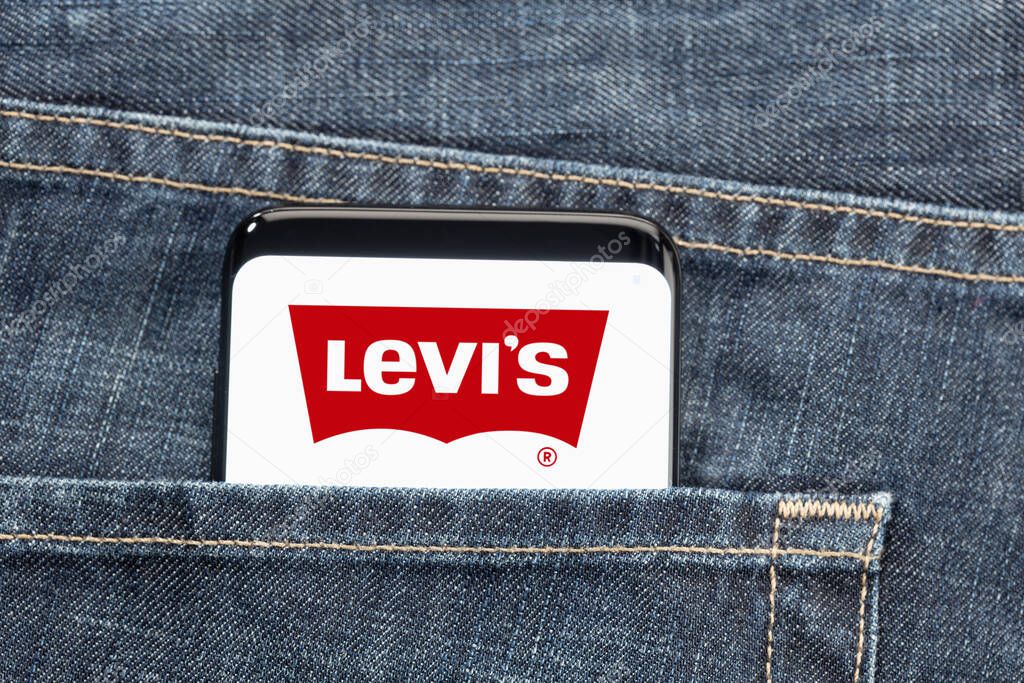 Galicia, Spain, july 27, 2021: Smartphone in pocket jeans with Levis logo on screen