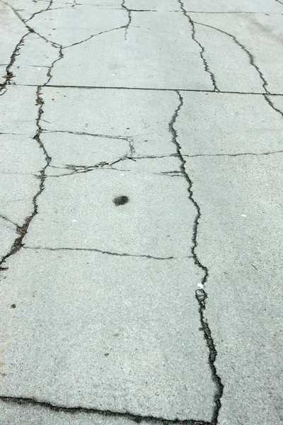 Paved road with holes as a background — Stock Photo, Image