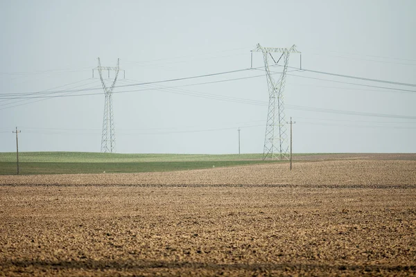 Agricultural field , with pylons - current — Stock Photo, Image