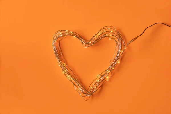 stock image Heart of led lights, perfect for lovers, for a romantic and full of love Valentine's Day. Plain orange background.