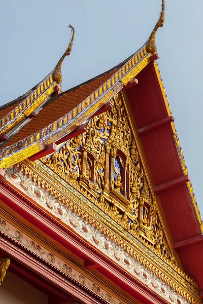 Small temple or chapel, with plant motifs drawn on its columns next to Phra tamnak Daeng, in Bangkok National Museum, example of Thai architecture.