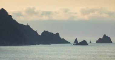 İspanya 'nın La Corua eyaleti Ortegal Burnu yakınlarındaki Ortigueira Galiçya sahilinde nefes kesici yaz günbatımı manzaraları, dağlık, sisli ve bulutlarla dolu..