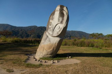 Statue of the Palindo megalith, from unknown prehistoric megalithic cultures, is located in the Bada Valley, Central Sulawesi, Indonesia clipart