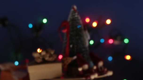 Carrusel de Navidad con un árbol de Navidad y regalos brillantes. Árbol festivo de Año Nuevo con regalos en el fondo de una guirnalda brillante.Decoración para el nuevo año. — Vídeo de stock